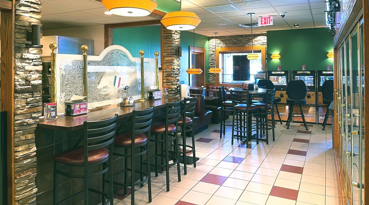 Joe's Pizza and 6 Pack restaurant interior with fresh pizza